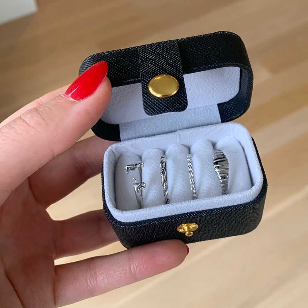 Black leather travel ring case with gold hardware ring holder